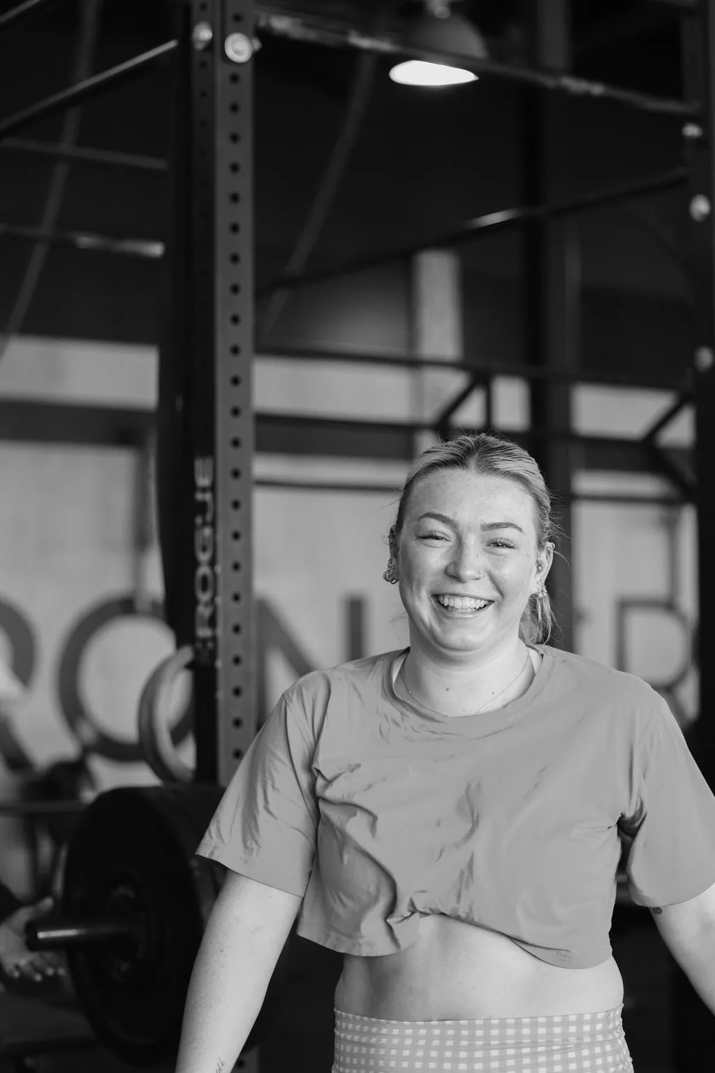 Member laughing on the gym floor after a session